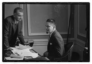 A man seated at a desk