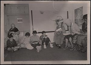 Group of people sitting and reading