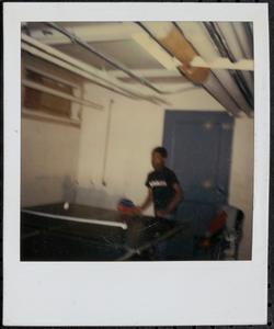 Boy in black shirt playing ping pong
