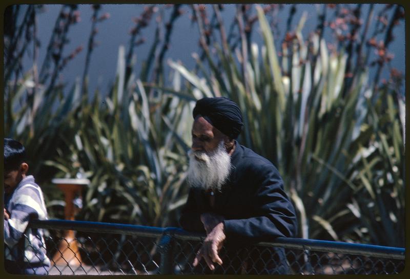 Man looking over fence