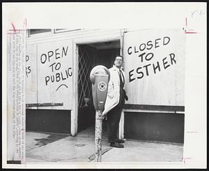 Esther is Barred -- A local merchant stands in front of his store day after boarding up the glass front and to add a bit of levity to the stormy weather painted this sign on the wood, "Open To The Public-Closed To Esther", referring to the Hurricane which is now expected to vent its fury further north of the city.