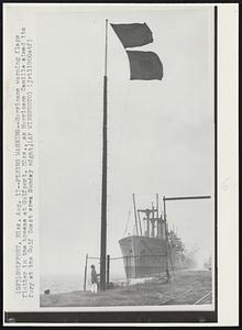 Flying Warning--Hurricane warning flags flutter in the breeze at Gulfport, Miss., as Hurricane Camille aimed its fury at the Gulf Coast area Sunday night.