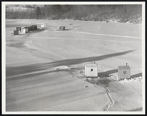 It's Smelt Fishing Time in New England tidal streams like the Eastern River, Dresden, Me., above. Inside smelt shanties, baited hooks on multiple drop lines are taken fast and furiously by schools of the small, delectable silvery fish when runs are on.