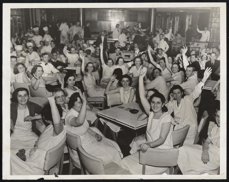 Before Police Stopped a Sit-Down Employees of the Book-Cadillac Hotel here are shown in the Casino of the Hotel April 1 where they staged a two-hour sit-down strike, due to impatience because negotiations for final settlement of a previous strike appeared to be lagging. The strike lasted until the arrival of police Superintendent Fred Frahm, with two hundred policemen, who threatened to throw them out. Thereupon, the strikers voted unanimously to leave, after agreeing to picket the Hotel.