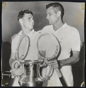 Before the Finals in the men's singles of the National Tennis championships at Forest Hills, Australia's Frank Sedgman (left) and Gardnar Mulloy, Miami, Fla., each took a grasp of the Challenge trophy. Sedgman blasted Mulloy in straight sets, 6-1, 6-2, 6-3, to take possession of the cup.