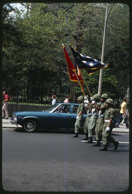 Men in uniform holding flags, Granary Burying Ground in background, Festival Puertorriqueño 1976