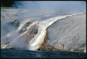 Steam rising from cascades down to water, Yellowstone National Park