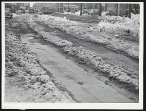 Plowed by Nature--This view of the chocolate slush path made by sun and thawing temperature was taken on Columbia road near Uphams corner, Dorchester.