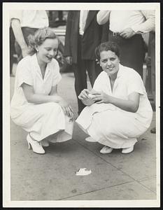 Skeptics said it couldn't be done, but these girls did it-- fried an egg on Tremont street yesterday afternoon. Left to right, Miss Franc Walker, of Brockton; the fried egg, and Miss Olive Silver, of Somerville.