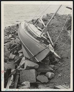 A Rocky Mooring-This yacht based at Lynn was swept 20 feet onto the shore and came to rest high on the rocks. Similar incidents occurred along other sections of the North Shore.
