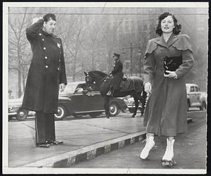 Strikes Don't Bother Her - Dorothy Gentner, beating the transit strike in Philadelphia, skates past a puzzled policeman as she arrives downtown after a five-mile trip from her home. She had little trouble on her way to work.