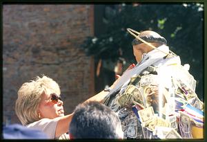 Boston - North End 2002: Venerating the saint a woman touches a statue of St. Anthony during feast of St. Anthony