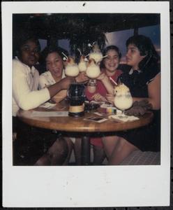 Four young women having fruity drinks