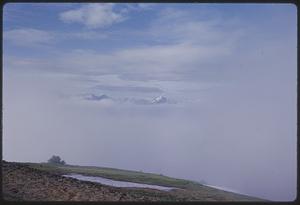 View of mountains through clouds, probably Washington