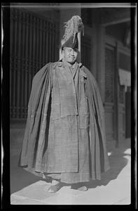 Unidentified man in robe and tall hat