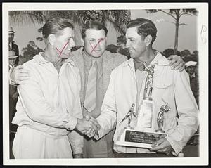 Shea Congratulated on Golf Victory Lloyd Brown (left) congratulates Merv Shea, coach of the Detroit Tigers, after the latter received at St. Petersburg, Fla., on Feb. 9 the winner's trophy of the Annual Baseball Players' Golf Tournament. Between them is Jimmy Foxx, host at the tournament.