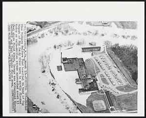 Hospital Hit--United Mine Workers Welfare Fund hospital in bend of Tug Branch of Big Sandy River here is partly flooded today as rain-swollen stream approached crest 13 feet above flood stage. Damage was widespread through Kentucky and West Virginia flood area.