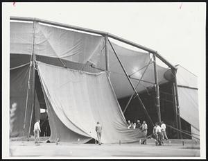 Once Warned Twice Prepared: Workmen removed nylon roof of Metropolitan Arts Center Theater on Charles River in anticipation of Esther's howling winds. Roof blew off in September 1960 hurricane.