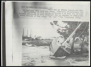 One of several boats demolished or beached in the outlying fury of Hurricane Camille lies on its side at a marina 15 miles west of Pensacola on the Intracoastal Waterway. There was more than $200,000 in boat and marina damage in the area.