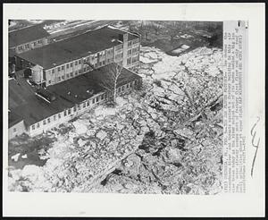 Ice Jam Floods Factory -- Ice chokes the Susquehanna River and thrusts against a factory building in this air view taken today as the river surged out of its banks behind a big ice jam. Water already covers part of factory first floor and only roof of small outbuilding shows at upper right.