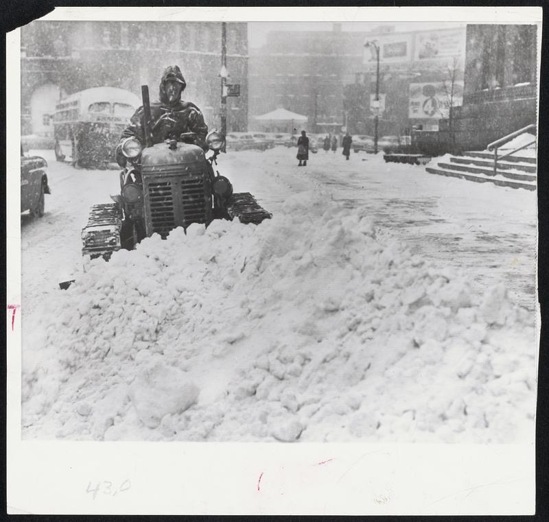 Just Like Home - George Carriero mans a plow in front of Buffalo City Hall. Sudden storm blew in from the northeast, giving Buffalo more than six inches of snow in less than six hours.