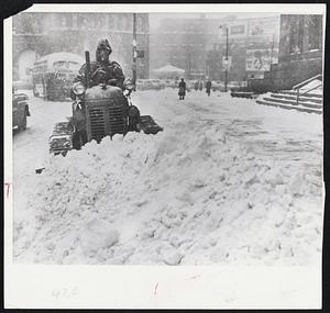 Just Like Home - George Carriero mans a plow in front of Buffalo City Hall. Sudden storm blew in from the northeast, giving Buffalo more than six inches of snow in less than six hours.