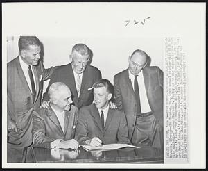 High School Ace Gets Athletics’ Contract - Lew Krausse, 18-year-old Chester, Pa., high school pitcher sits with Kansas City Athletics’ owner Charles O. Finley as he was signed in New York by the A’s today for a reported $125,000 bonus. Standing, left to right are Frank Lane, A’s general manager; Lew’s father, Lew Krausse, Sr., scout for the Athletics, and A’s manager Joe Gordon. Krausse has 18 no-hitters to his credit.