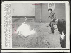 Draft Protester Almost a Victim-- Walter Skinner, 25, of Pasadena looks down to discover his clothes on fire near a basket of burning records taken from the Los Angeles induction station today. A companion, Charlies Friend, rear, came to his aid and helped put the fire out without injury to Skinner. Skinner, Friend and a third man were arrested on a charge of suspicion of conspiracy to commit burglary.