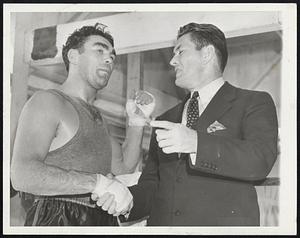 Yeah, The Left's All Right, But-- Max Schmeling (left), sprouting a fresh crop of whiskers at his training camp at speculator, N.Y., June 7, shows former Heavyweight Champion Gene Tunney the left hand with which he hopes to surprise Champion Joe Louis when the two meet June 22 in Yankee Stadium, New York City. Gene, however, was more impressed by Max's famous right hand, which he says is still the best in the business.