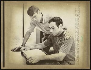 South Bend, Ind- Notre Dame end Jim Seymour, (L) and OB Terry Hanratty, the Fighting Irish's great passing combination, take time out from practice for 9/28 game with Purdue to catch up with their studies.