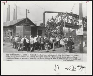 United Steelworkers pickets at the U.S. Steel Co. plant here swing into action following Monday's walkout. They erect their picket line "headquarters" as workers leaving the mill straggle down a footbridge over railroad tracks.