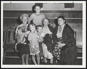 Huddled Out of the Storm, this group of women and children gather at the Red Cross center in Our Lady of Lourdes Church in Revere. Left to right are Miss Diana Cohen; Robin Mack, 4; Henry Mack, 10; Stanley Mack, 3; Mrs. Rose Cohen, and Mrs. Claire Mack.