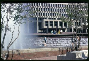 People in the Boston City Hall plaza fountain