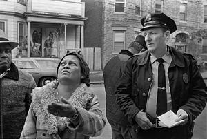 Chelsea police officer Herbie Sullivan collects information from a fire victim