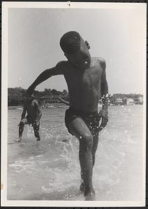 A boy playing in the surf at the beach