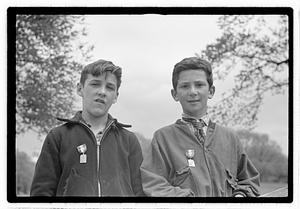 Two boys wearing medals