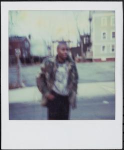 Young man outside in camouflage jacket