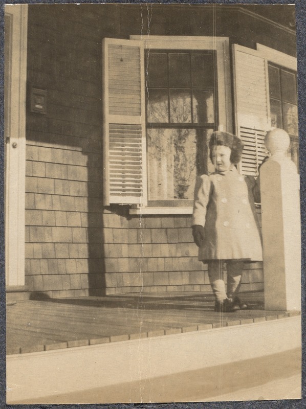 Child standing on porch
