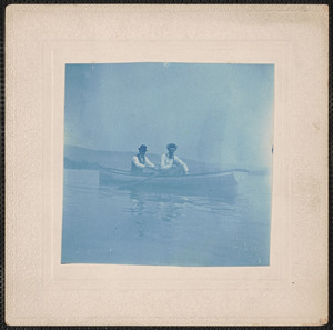 Photograph of two men in a canoe