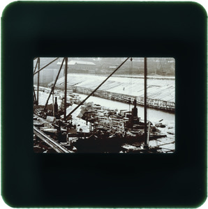 Construction of stone dam, wood dam in background