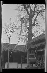 Incense burner and flag in courtyard