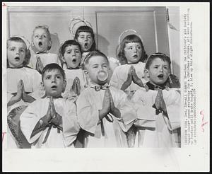All Gummed Up--When the Children's Aid Society "Angel Choir" posed yesterday for a Christmas picture, all went according to routine until Ernie Voight, 5, blew up this slight disturbance.
