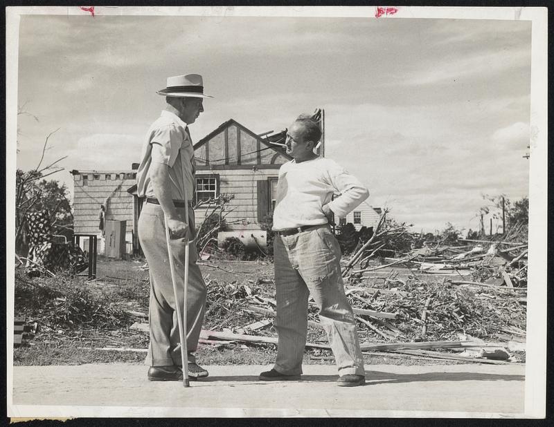 Plans for the Future are discussed by Richard J. Harris (left), who suffered a broken ankle in storm, and Arthur E. Bonin. Against this background of ruined homes on a Shrewsbury street, they, like their neighbors, foresee yet another day when homes and normal community life will be restored.