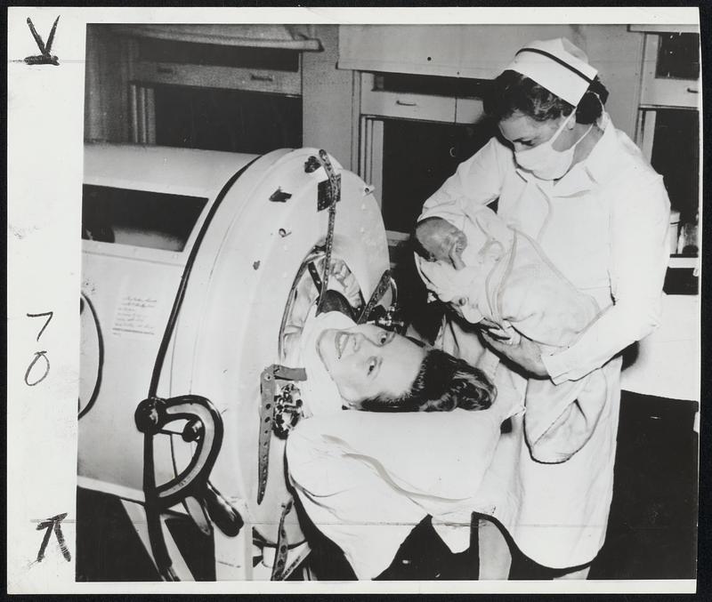 Child Born in Polio Ward-Mrs. Dorothy Crutcher of San Antonio, Texas, Infantile paralysis victim, smiles as her daughter, Sherilyn Kay, born in a hospital polio ward Monday, is brought for her to see.