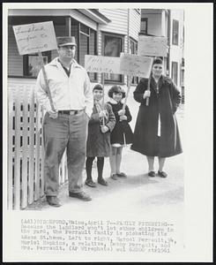 Family Picketing--Because the landlord won't let other children in the yard, the Perrault family is picketing its Adam St. home. Left to right, Marcel Perrault, 34, Muriel Hopkins, a relative, Debby Perrault, and Mrs. Perrault.