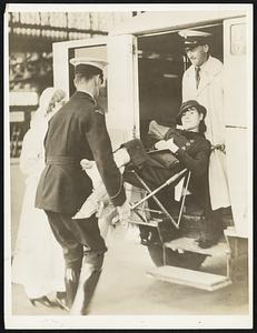 From "City of Death" -- This young woman, injured in the Quetta, India, earthquake, is being lifted into an ambulance upon her arrival in London. She is one of the survivors of the quake that devastated Quetta and killed an estimated 60,000 in the country as a whole.