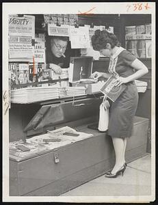 Playing in by Ear, TV actrice Ellen Madison "tunes in" the newest idea in magazines at the newsstand of Samuel Austrian in Manhattan (at 8th Ave. and 43rd St.). The magazine, which can be played as well as read, is called "Echo." The magazine has a hole running right through its center and the whole issue, containing non-detachable laminated plastic records, can be "played" on the phonograph. The first edition of "Echo" contains five five-minute recordings, which can be played on any phonograph at 33 1/3 speed.