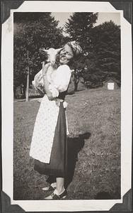 A woman holding a goat