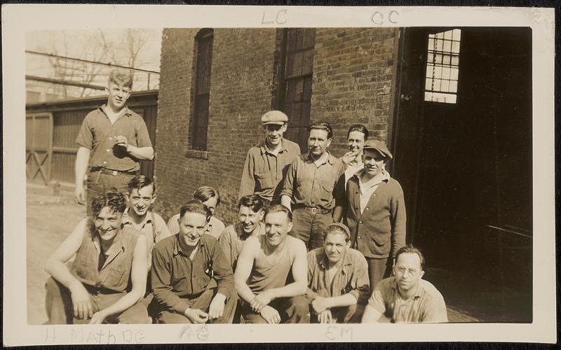 Mill workers in front of mill