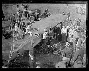 People examining a wrecked airplane